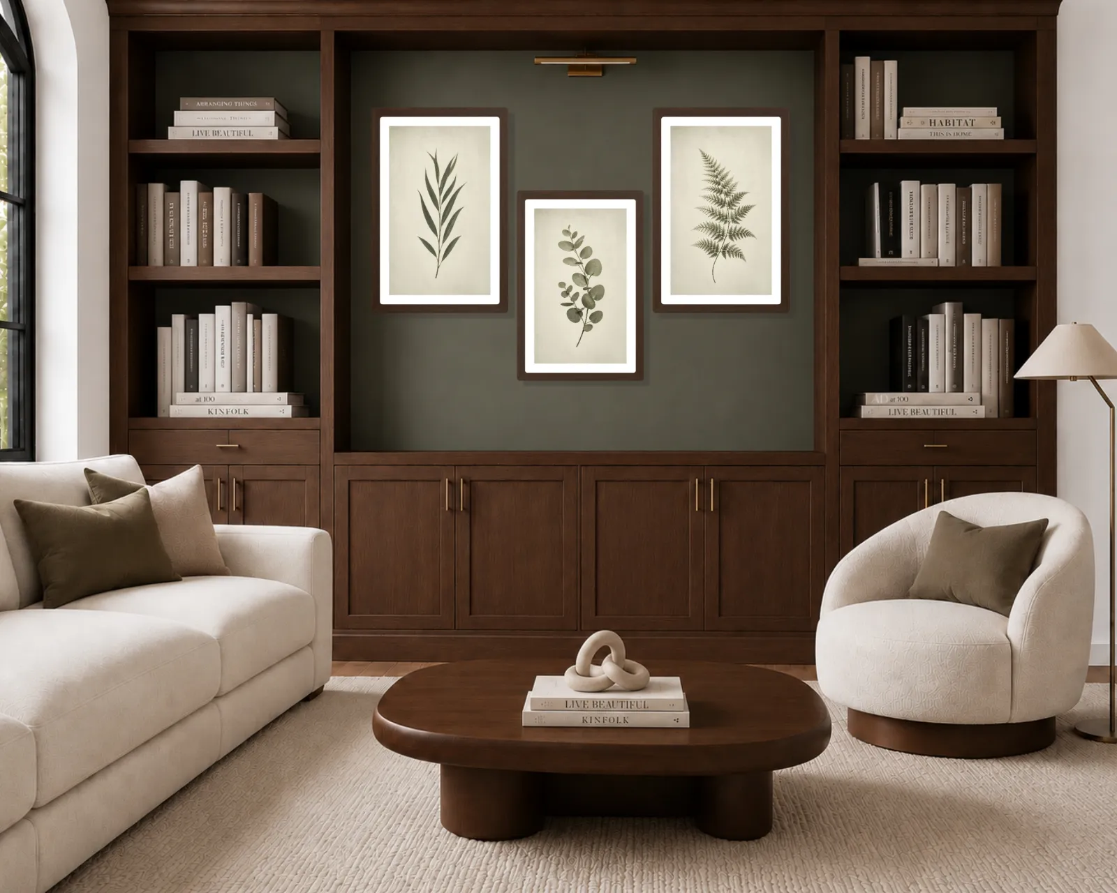 Organic modern living room with three vintage green botanical prints arranged within a dark wood built-in cabinet wall.